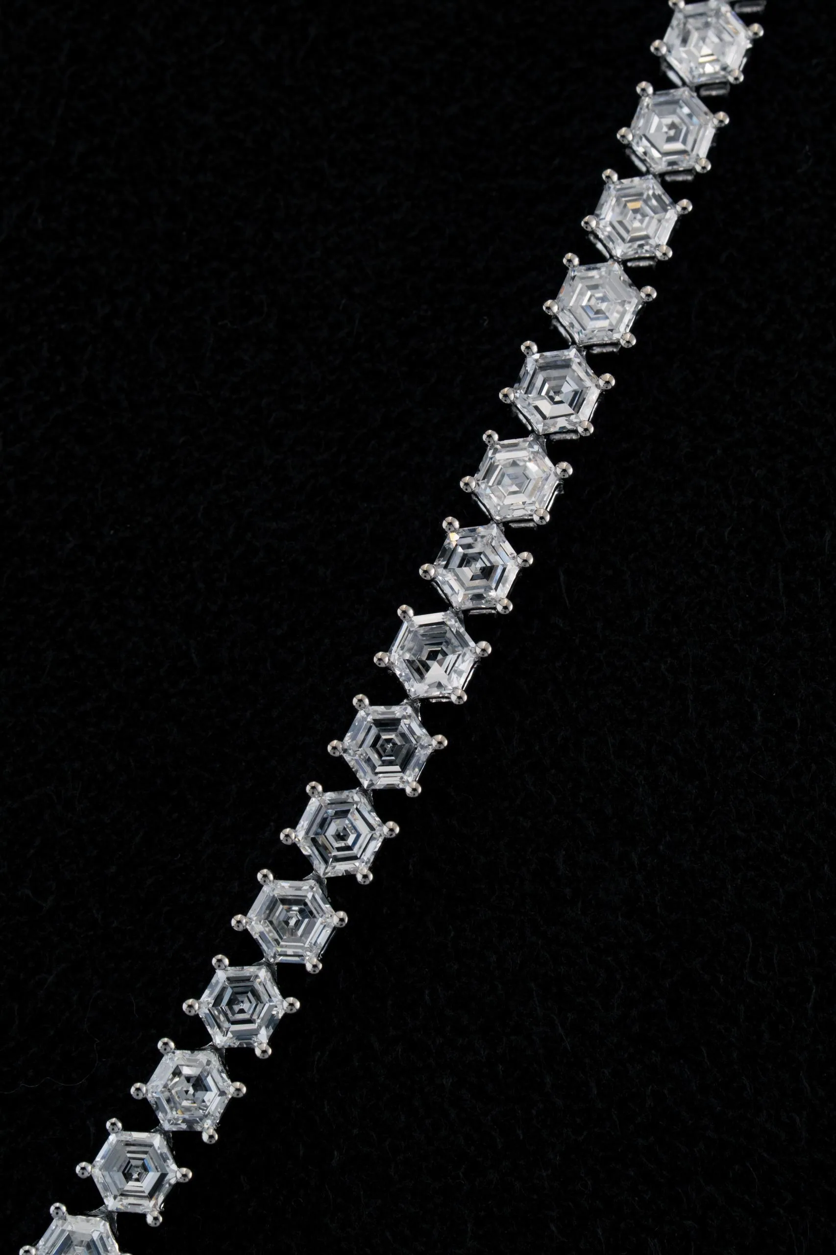 Macro of the hexagon-cut stones, each in its six-claw setting.