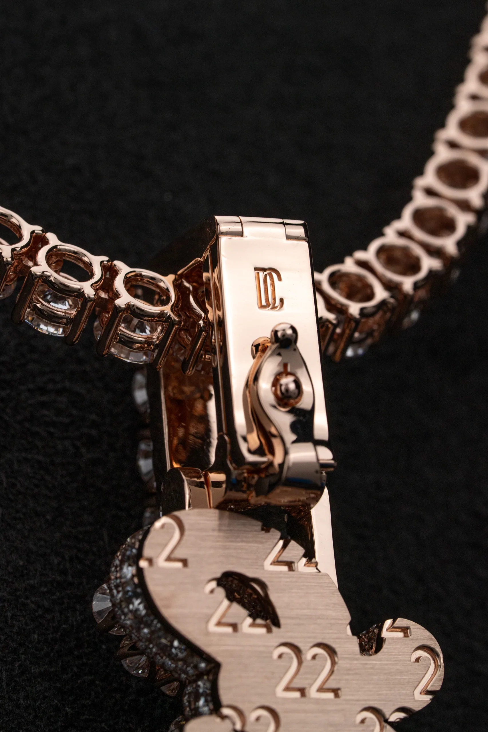 The tennis chain's links traced in low, warm highlight.