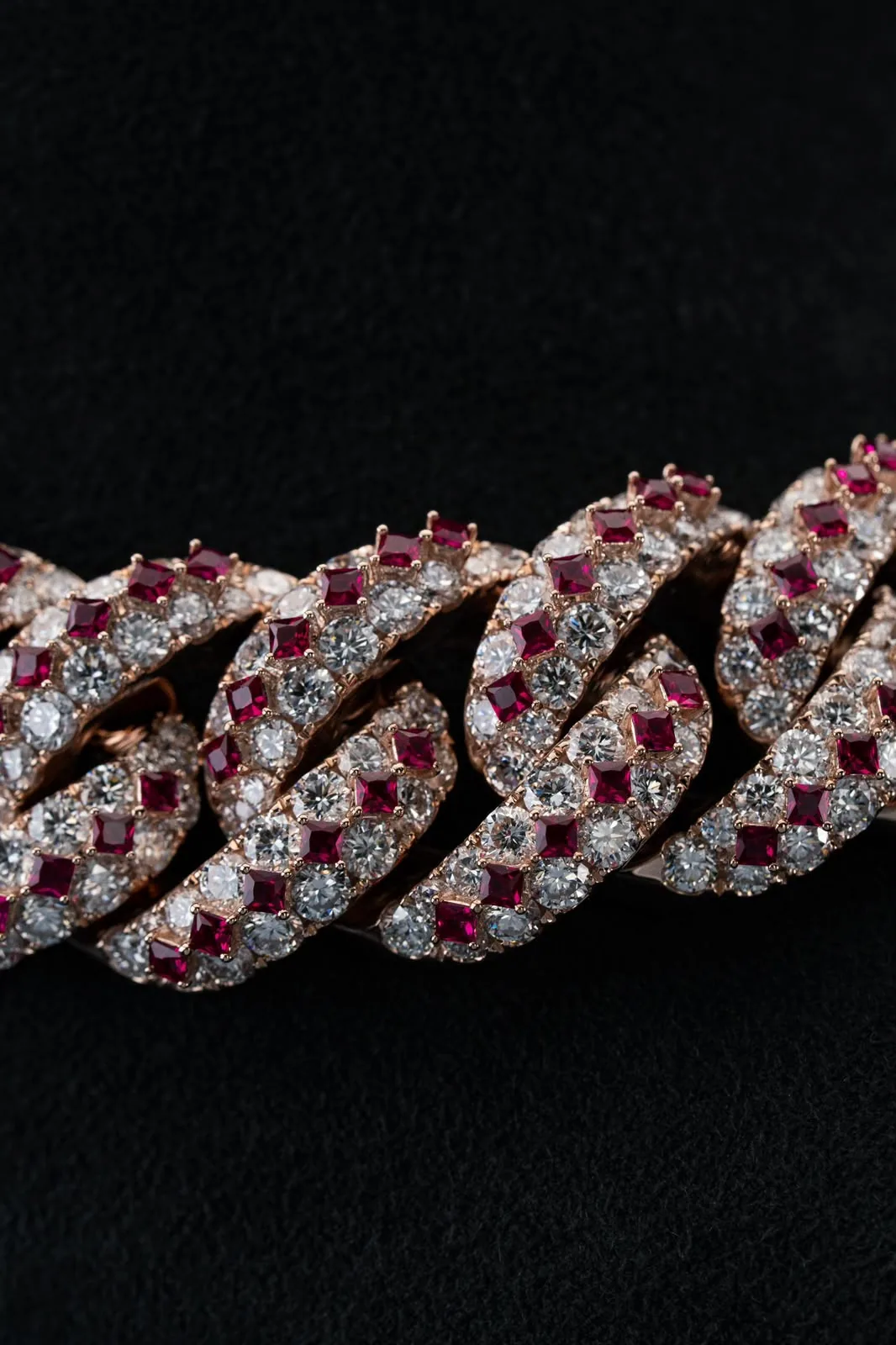 Macro of the links, diamonds and square-cut rubies alternating in the pavé.