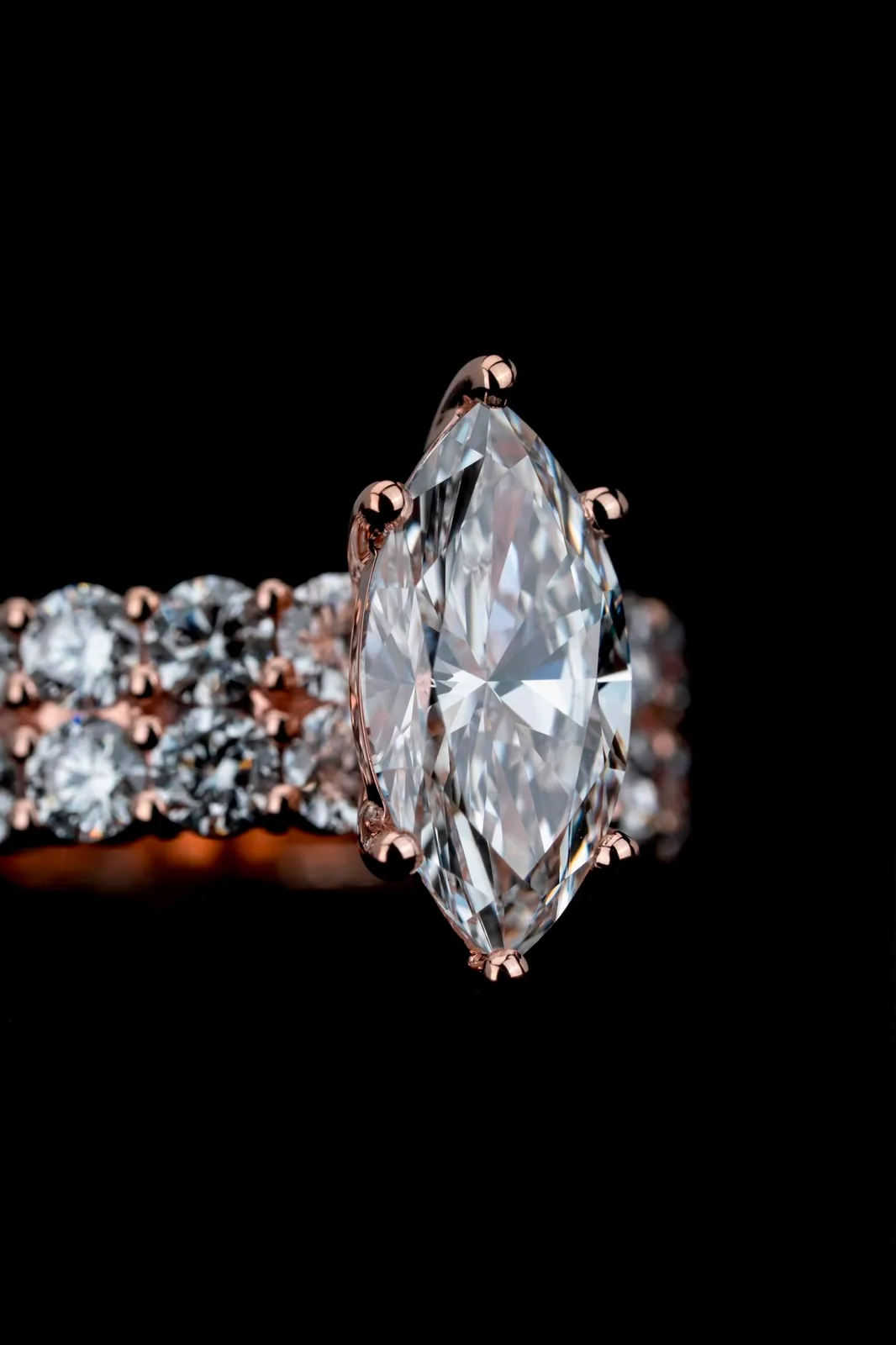 Macro of the marquise cut held in its rose-gold claws.