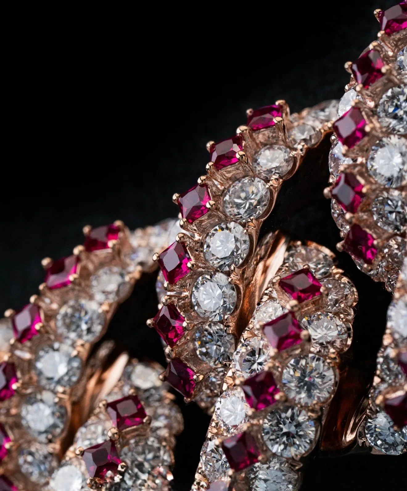 An extreme close study of the setting, rubies deep against the stones.
