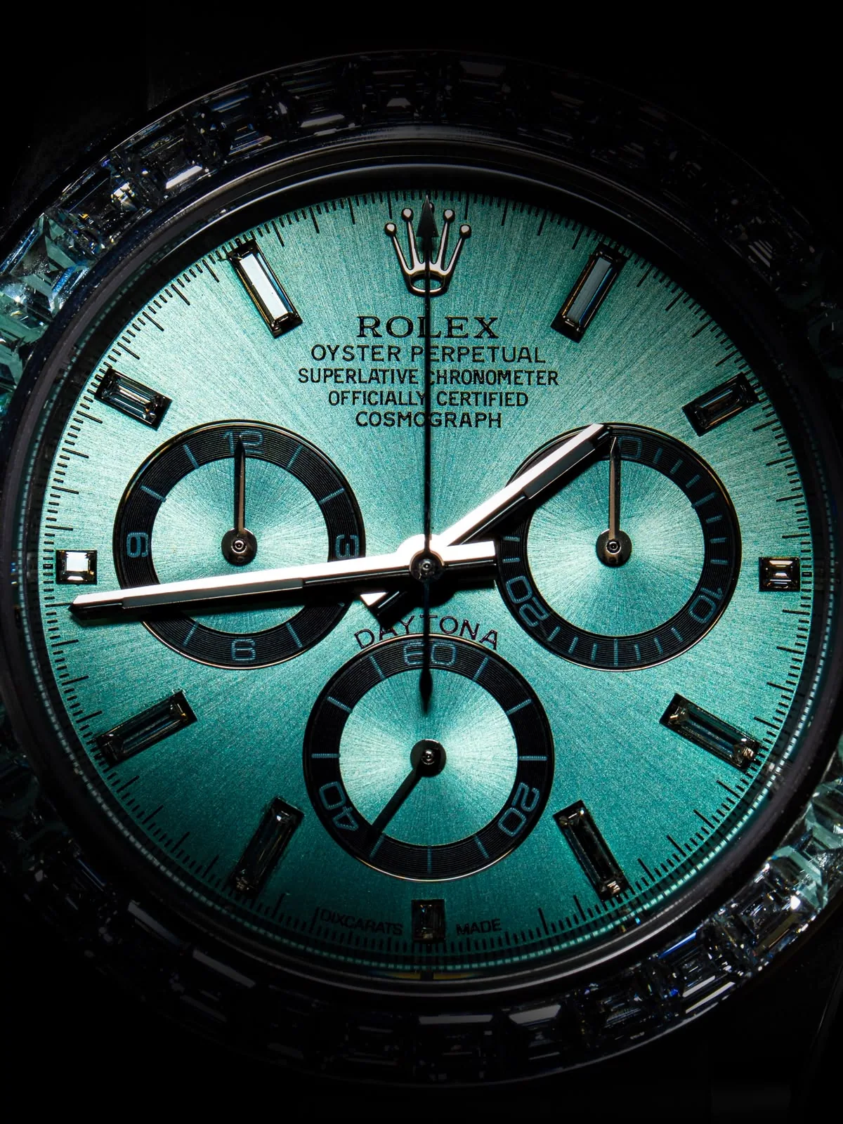 The dial straight on, its gradient running from pale turquoise to deep green.