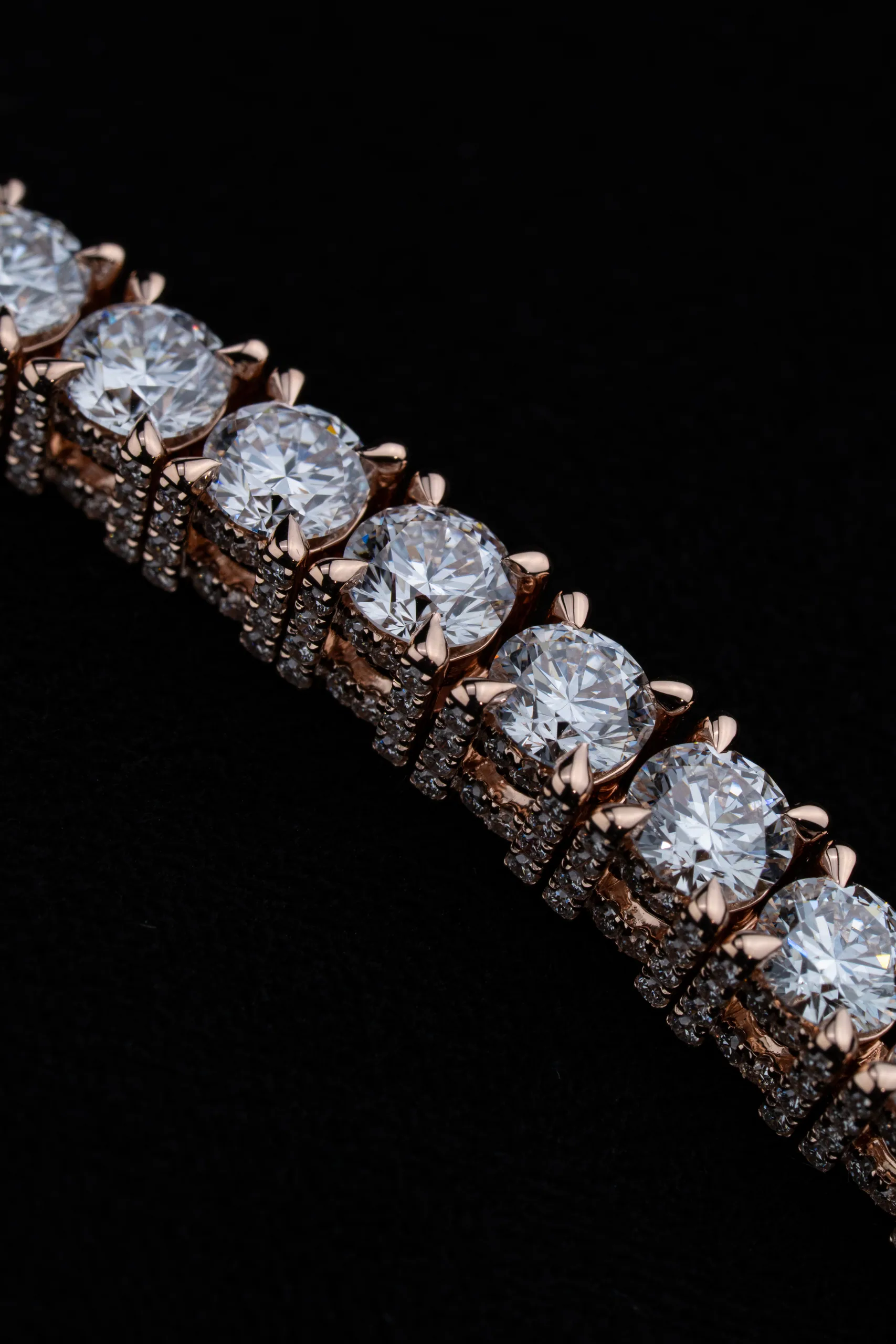 The bracelet's line dissolving into surrounding shadow.