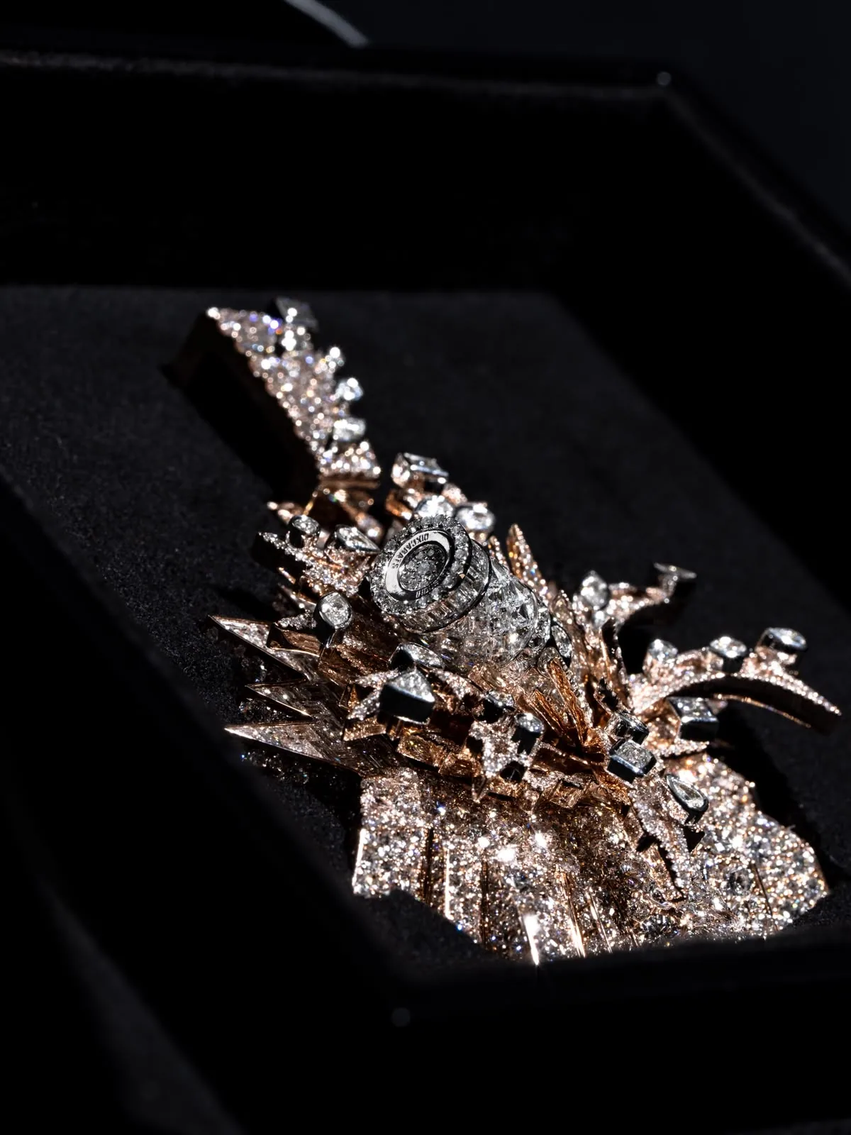 Macro of the starburst pendant, its rays radiating from a central stone.