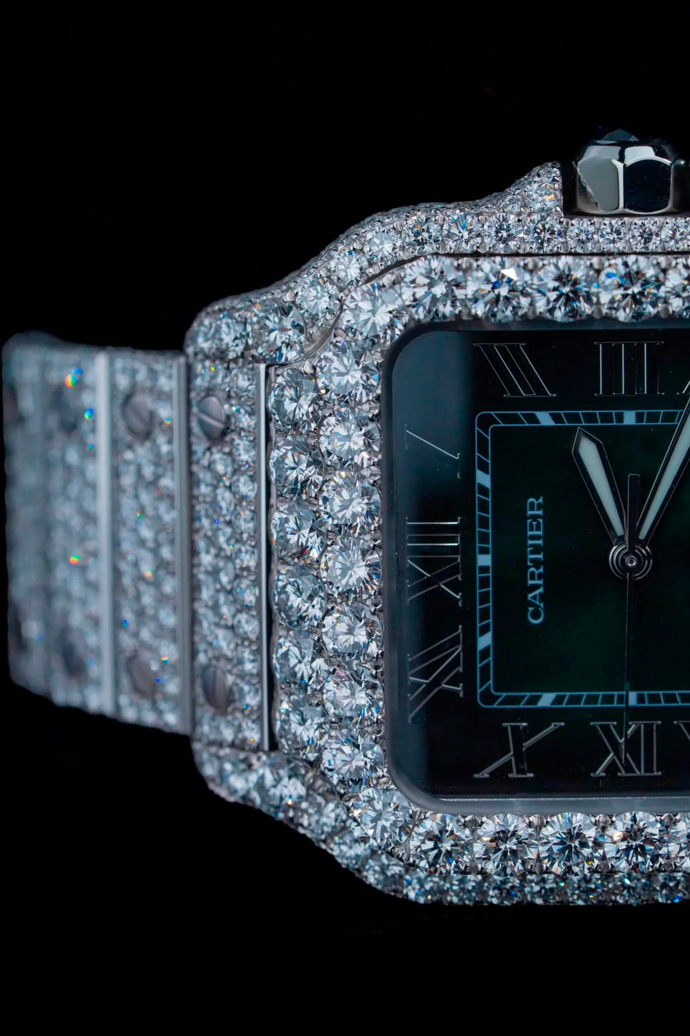 Close on the case, rows of large diamonds beside the green dial and its luminous hands.