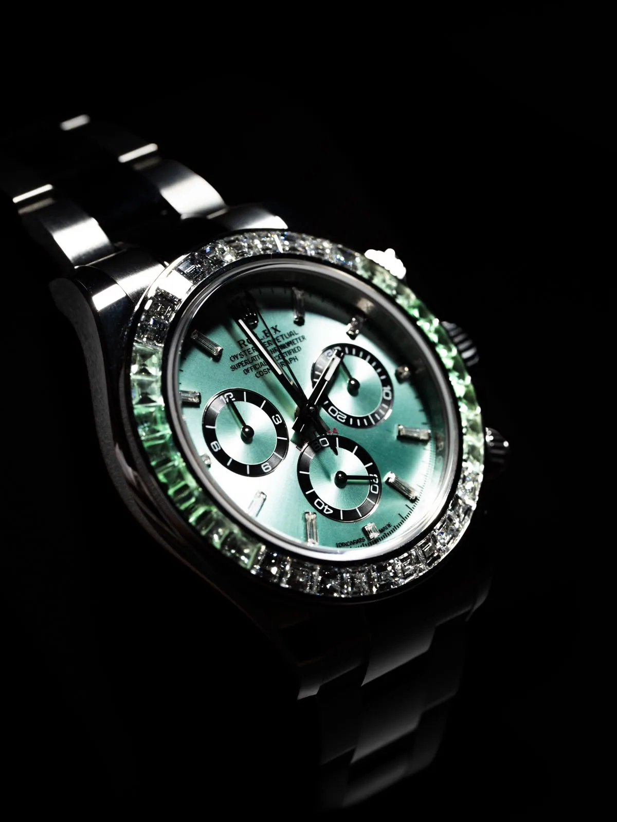 A three-quarter view of the case and bracelet, light running along the set bezel.