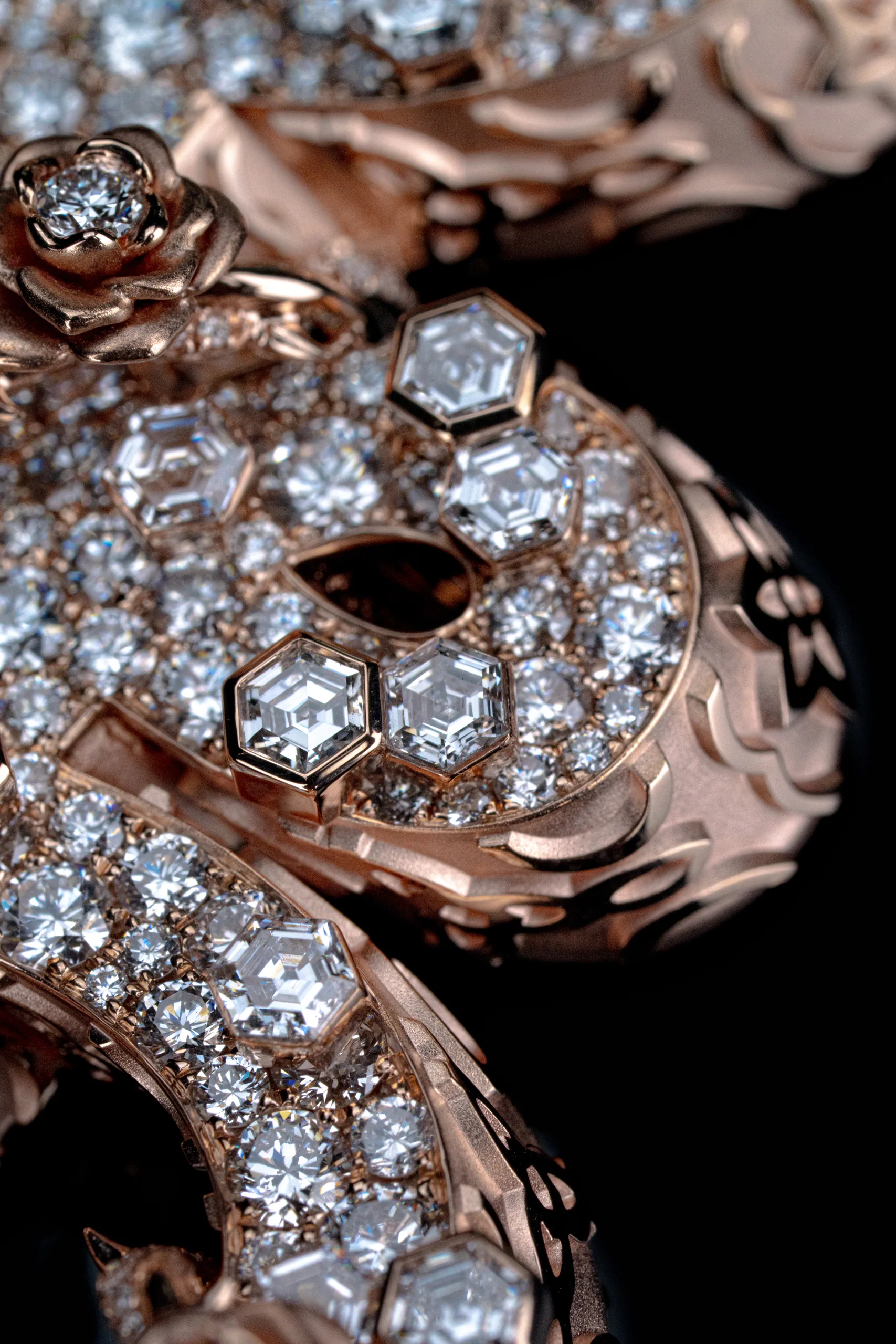 Diamonds gathered along the script's inner curve against shadow.