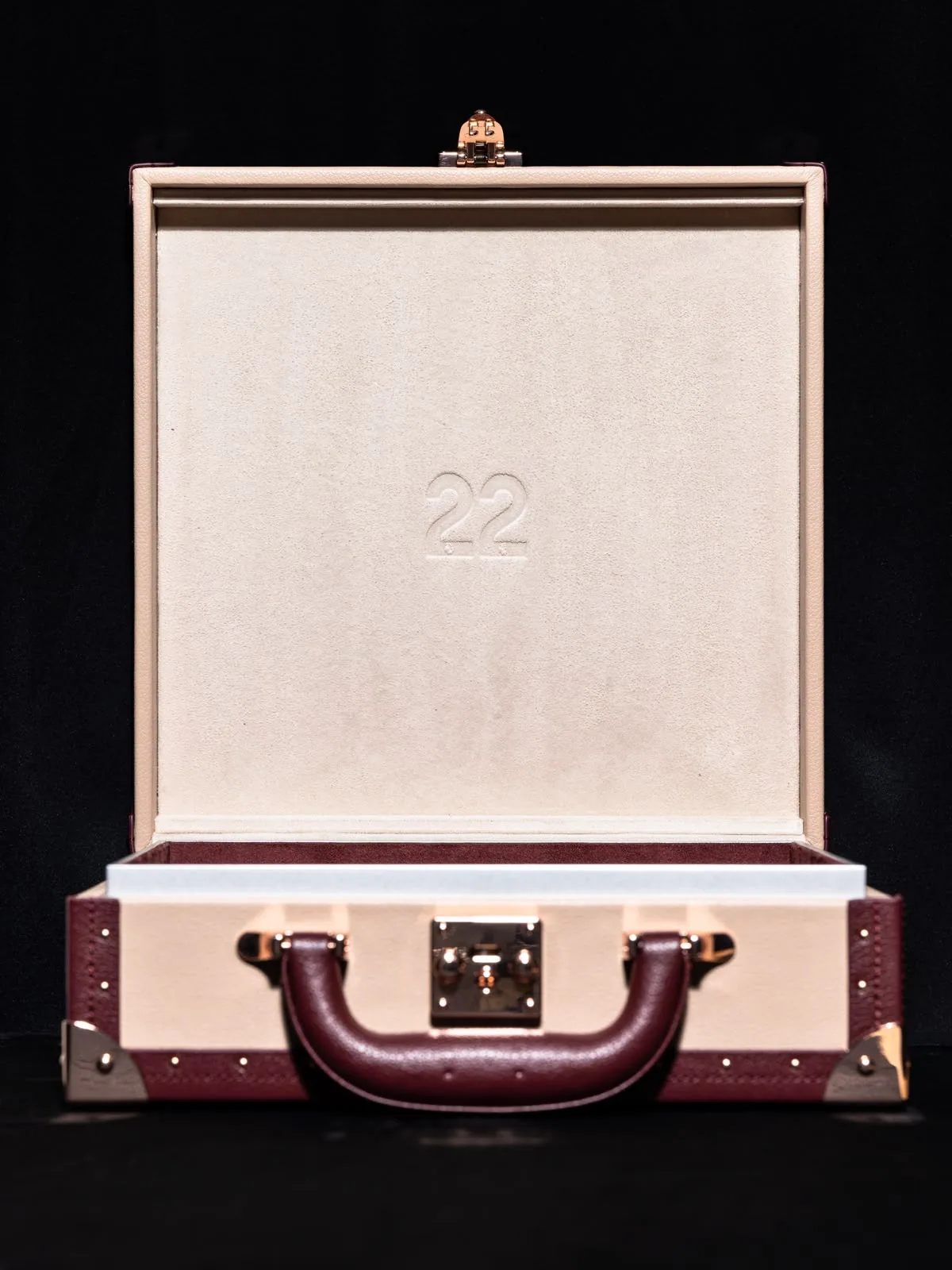 The écrin open and empty, its pale interior lid embossed with a number.