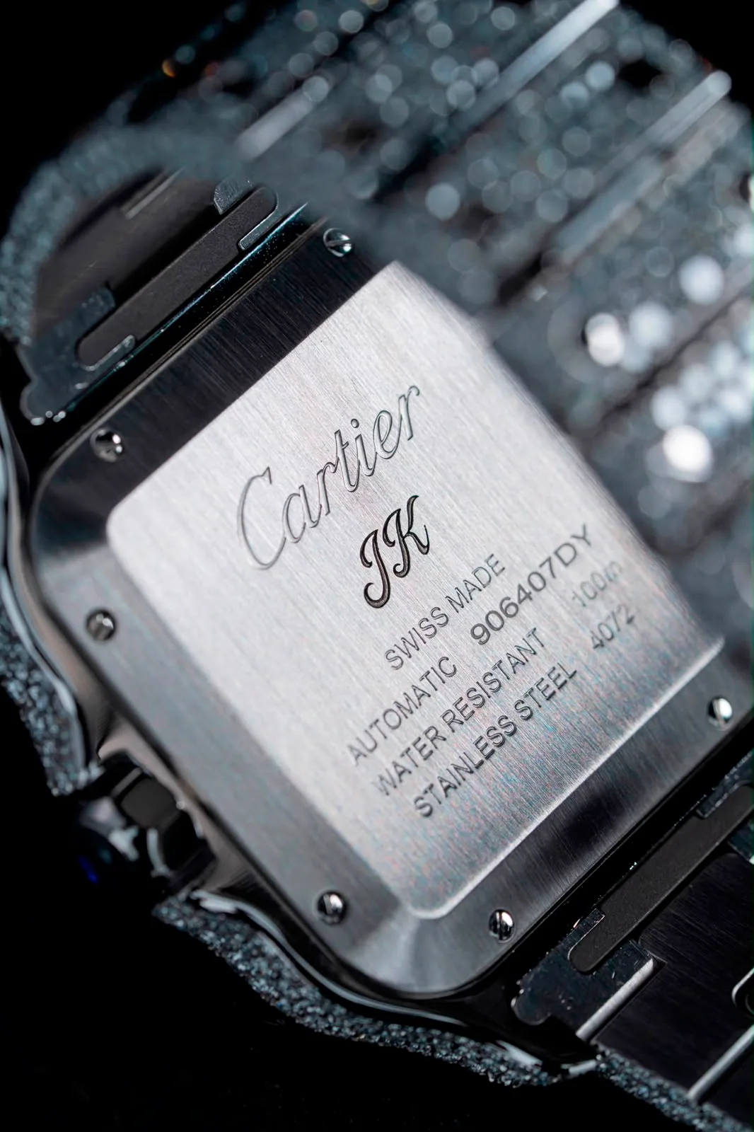 The brushed steel caseback, engraved with the Cartier signature.