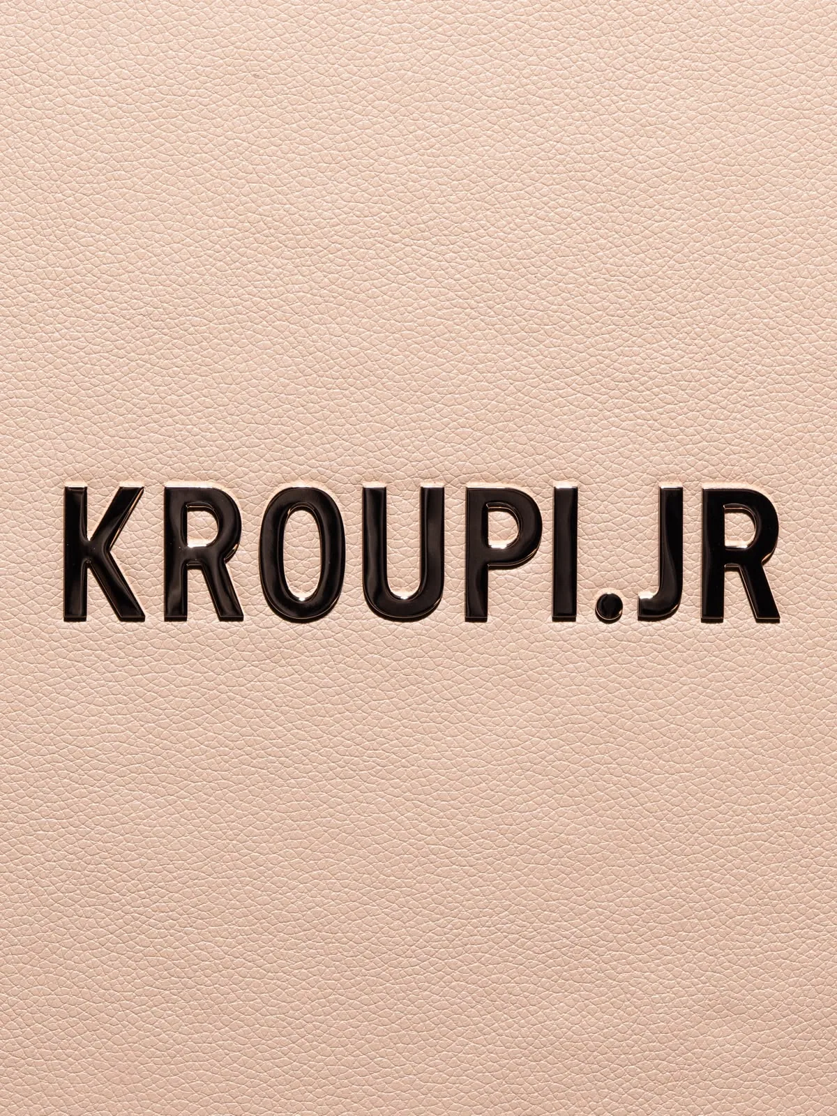 Macro of the printed name on the grain of the cream panel.