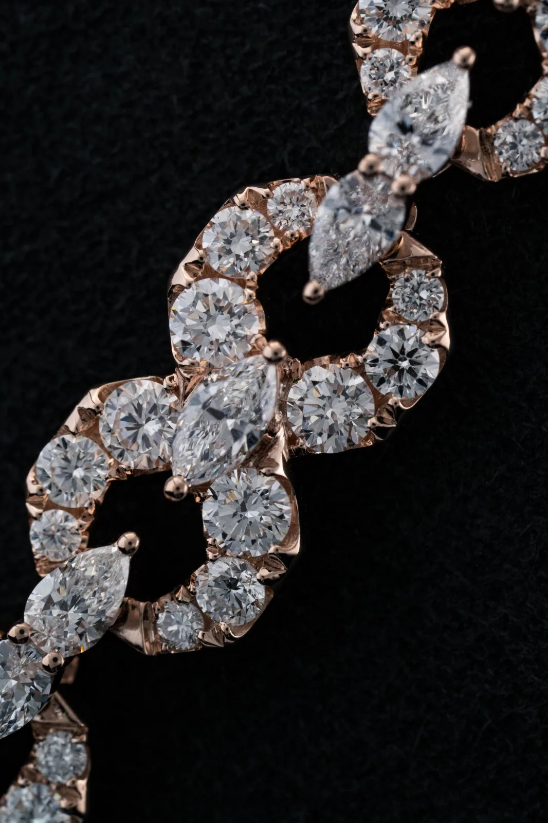 The chain turned to scatter points of light across its marquise stones.