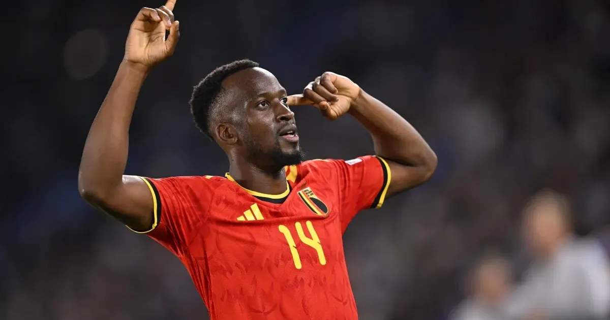 Dodi Lukébakio in a red Belgium shirt, a finger to his temple.