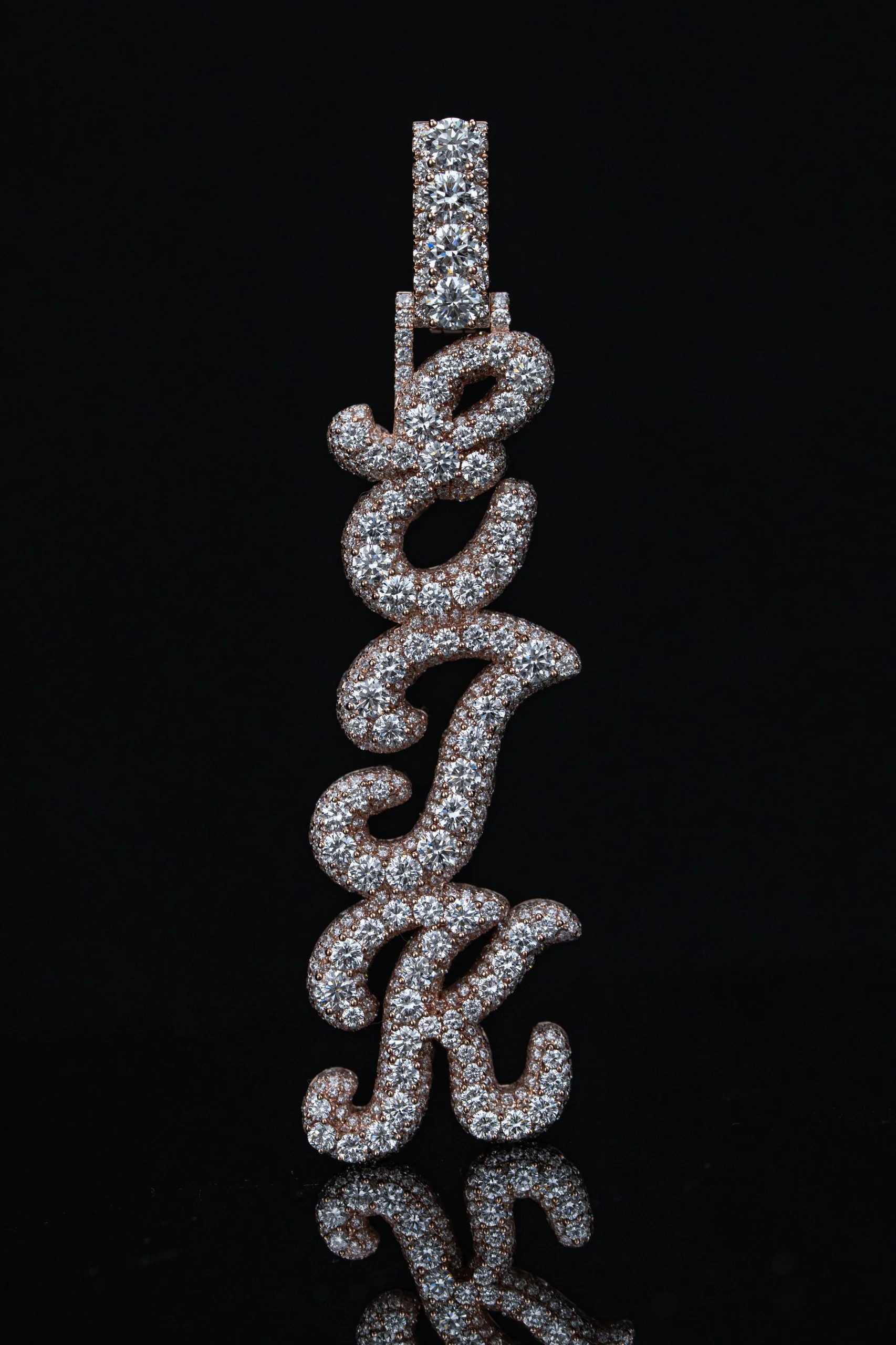 The pendant on its tennis chain against deep shadow.