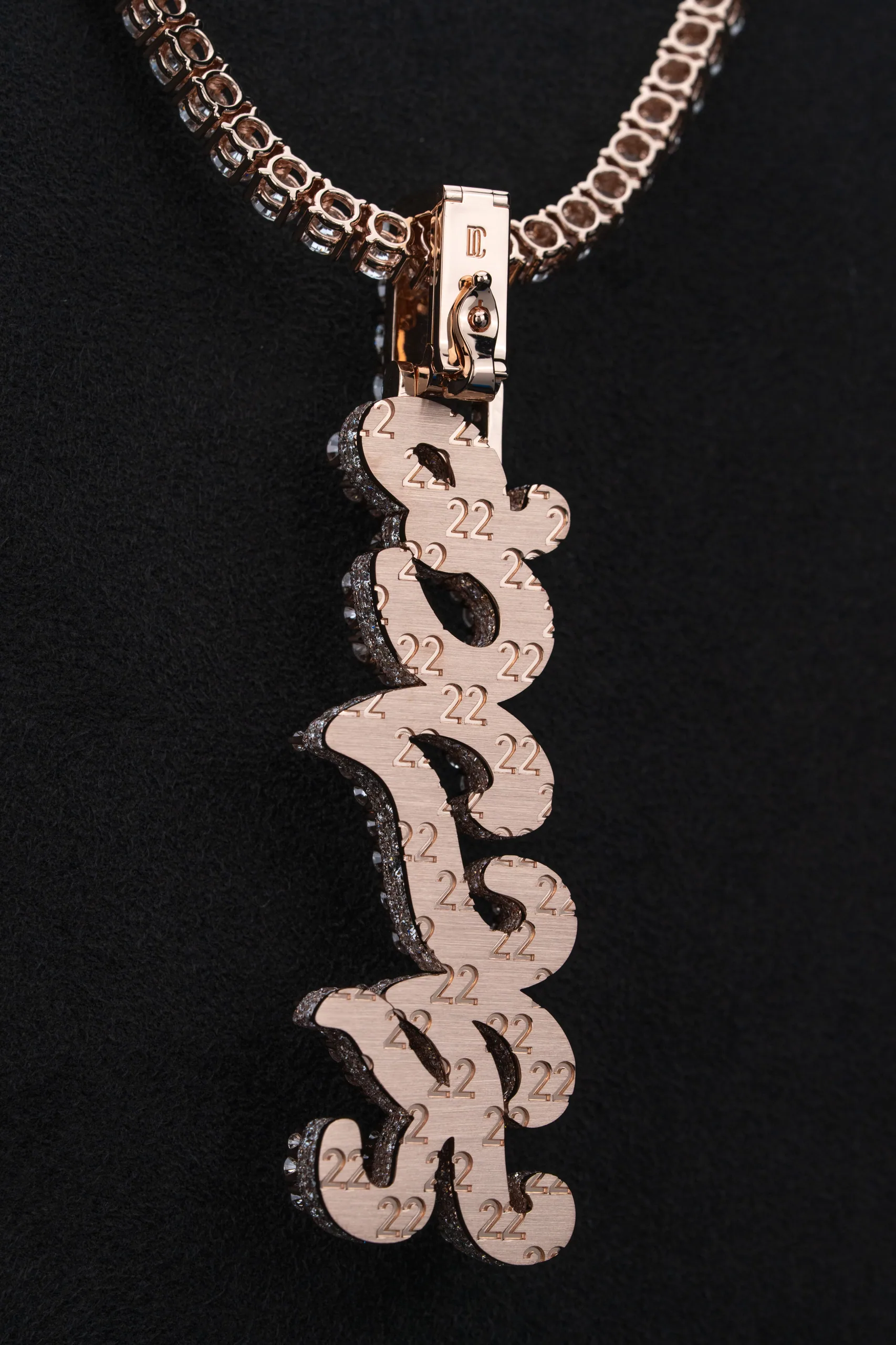 The reverse of the pendant edged in warm light.