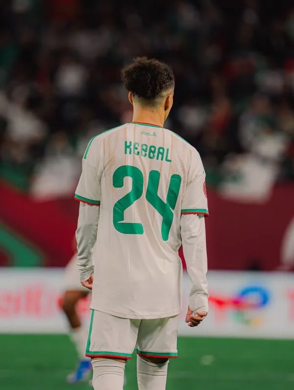 Ilan Kebbal seen from behind on the pitch, his name and the number 24 across his shirt.