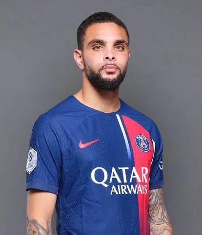 Layvin Kurzawa in a navy Paris Saint-Germain shirt, looking into the camera.