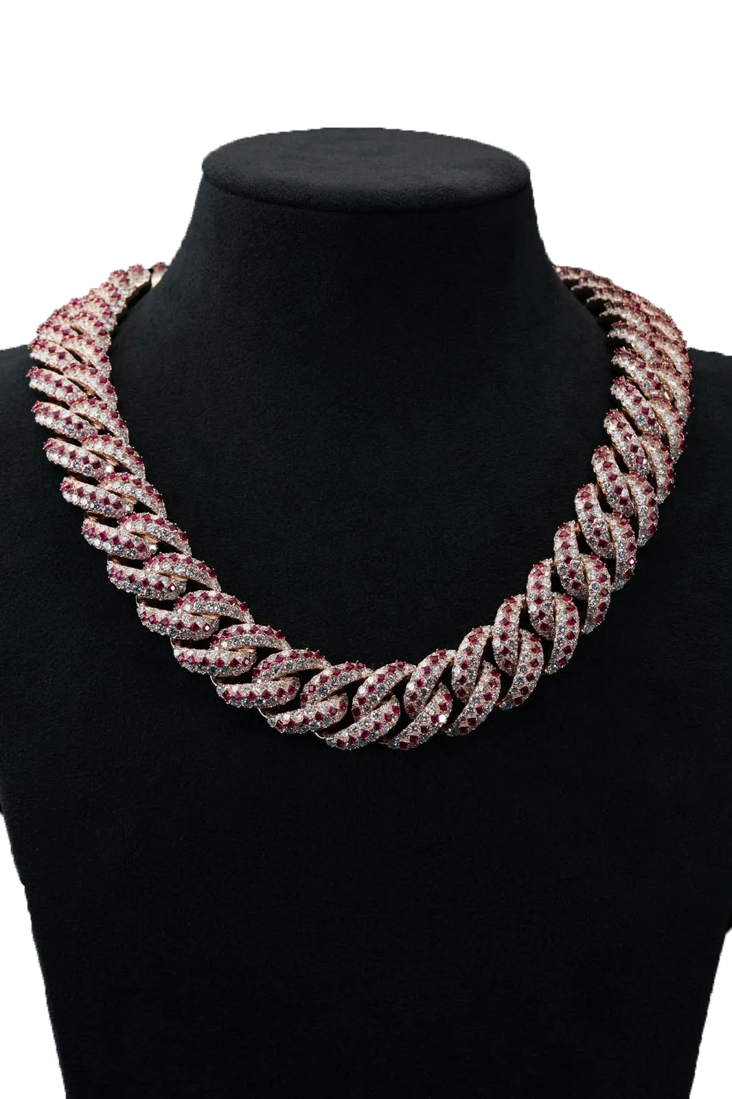 A rose-gold Cuban link necklace on a black velvet bust, every link paved with diamonds and set with square-cut rubies.