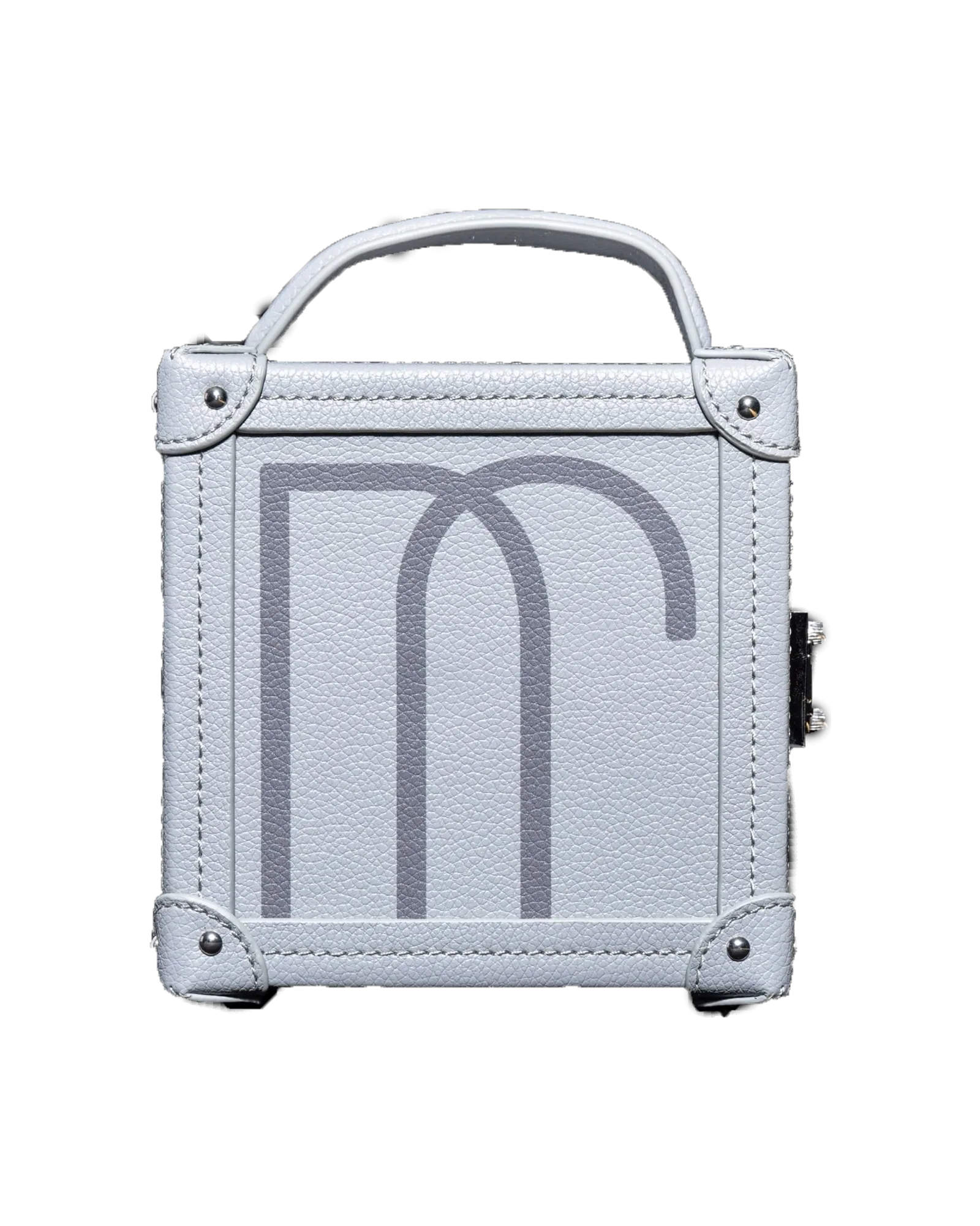A white leather trunk cut out against near-black, a pale monogram embossed across its front.