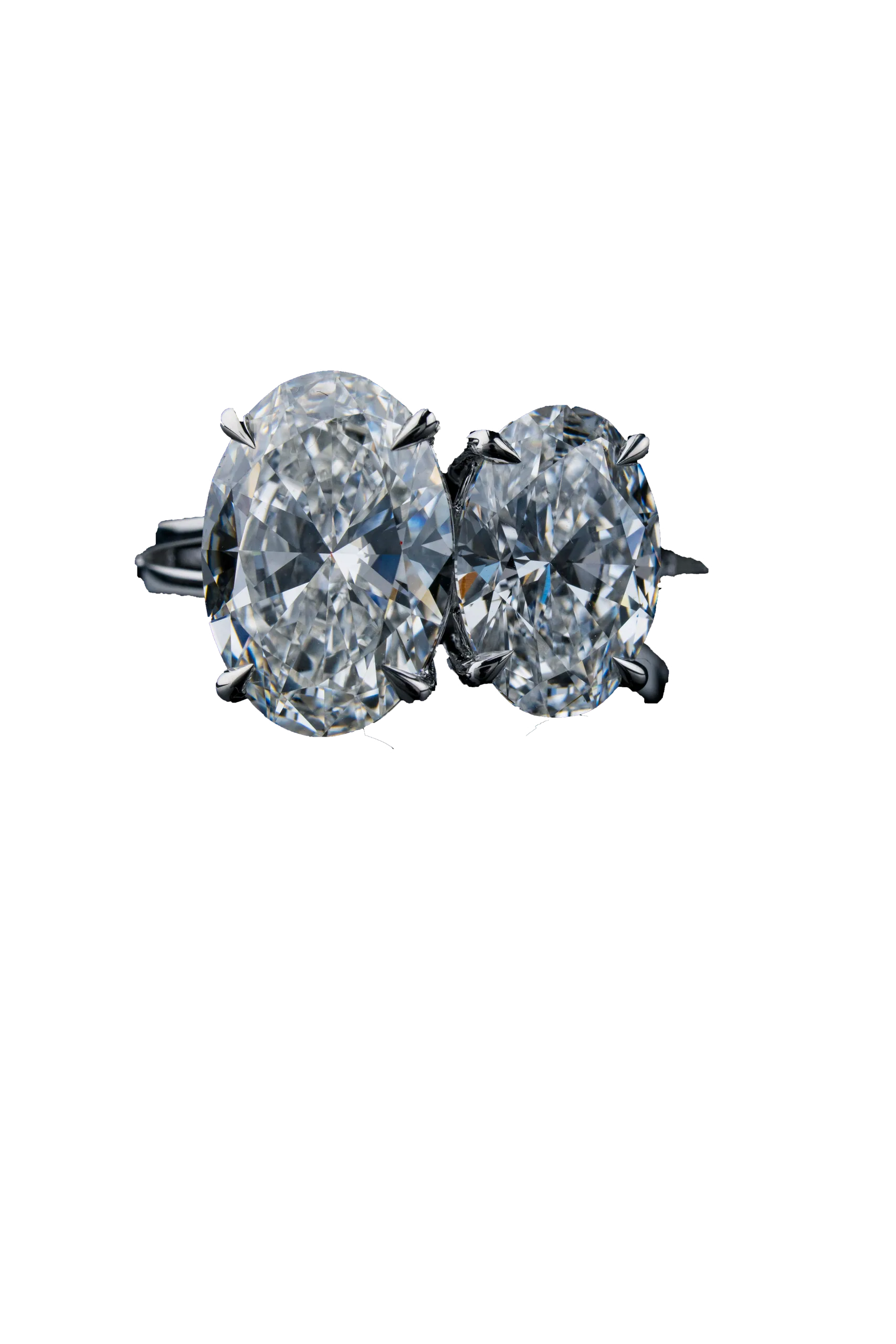 A white-gold ring cut out against near-black, two oval-cut diamonds set side by side in claw settings.