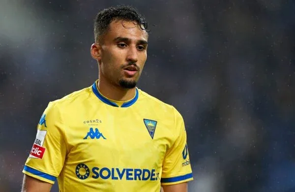Rafik Guitane in a yellow shirt, looking aside.